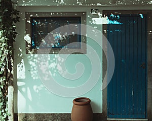 Beautiful shot of a small house with a blue wooden door in Italy