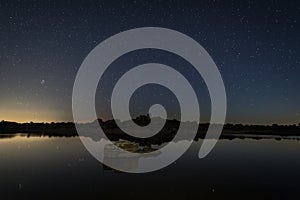 Beautiful shot of a starry sky over a lake in the Natural Area Barruecos, Spain