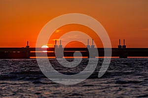 Beautiful shot of a storm surge barrier in Zeeland province of the Netherlands during the sunset