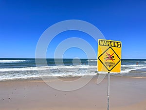 Beautiful shot of a symbol of warning about danger near the sea