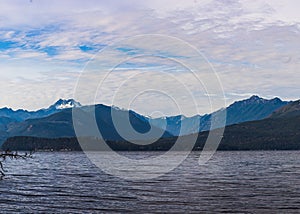 Beautiful shot of a tranquil lake surrounded by forested mountains