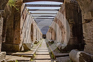 Beautiful shot of a tunnel in the coloseum interior under the sky in Rome, Italy