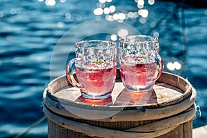 Beautiful shot of two pink lemonades with ocean water in the background