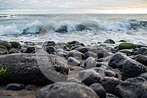 Beautiful shot of waves splashing against a rocky shore in Sao Miguel, Acores, Azores, Portugal photo