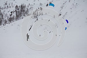 Beautiful shot of the winter sport of kite skiing on the moutnain pass of Simplon, Switzerland