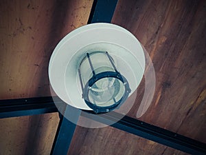 Beautiful shot of a wooden ceiling and a metallic lamp