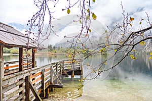 Beautiful shot of a wooden cottage with wooden railings on a lake