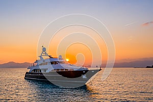 Beautiful shot of a yacht sailing on the sea at sunset