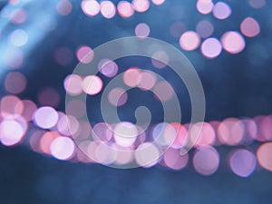 Beautiful side on a dark background. Pink shimmer and circles on a blue and gray background. Festive abstract background