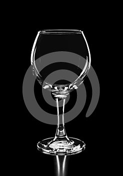 Beautiful silhouette of empty wine glass on black backg