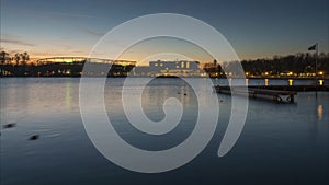 Beautiful silhouette of evening Hanover and huge artificial lake Maschsee. Germany. Time lapse.