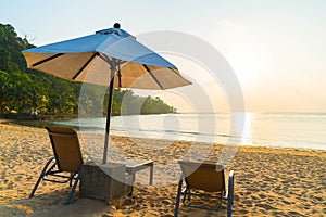 Beautiful Silhouette luxury umbrella and chair around swimming p