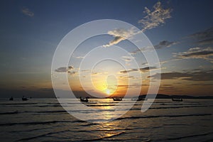 Beautiful silhouette of ship and long tail boat on sea or ocean with blue sky and cloud at sunset, sunrise or twilight time