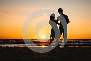 Beautiful silhouettes of dancers at sunset