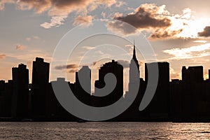 Beautiful Silhouettes of Skyscrapers in the Midtown Manhattan Skyline during a Sunset over the East River in New York City