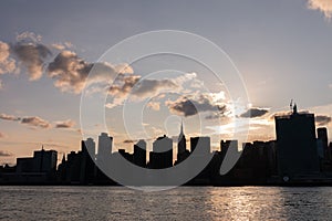 Beautiful Silhouettes of Skyscrapers in the Midtown Manhattan Skyline during a Sunset over the East River in New York City