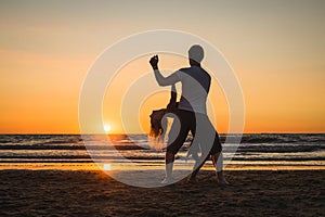 Beautiful silhouettes of dancers at sunset