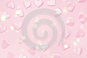 Beautiful silk pink hearts on a pink background. Holiday concept Valentine`s Day. Flat lay.