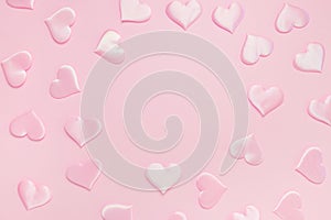 Beautiful silk pink hearts on a pink background. Holiday concept Valentine`s Day. Flat lay.