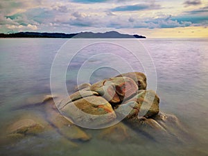 Sunset view with silky smooth water reflection on the sea shore landscape with beautiful sunset view.