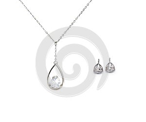 Beautiful silver necklace and diamond earrings isolated on white photo