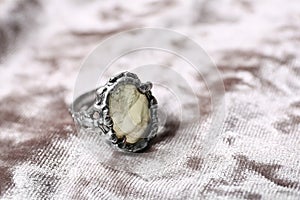 Beautiful silver ring with prehnite gemstone on light fabric