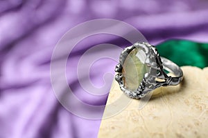 Beautiful silver ring with prehnite gemstone on textured surface