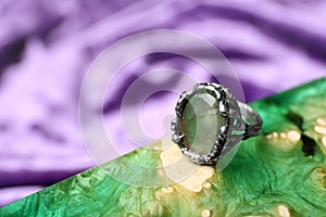 Beautiful silver ring with prehnite gemstone on textured surface