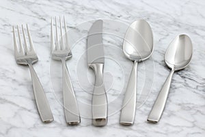 Beautiful silverware on carrara marble