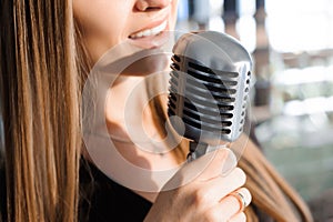 Beautiful Singing Girl. Beauty Woman with Microphone. Glamour Model Singer. Karaoke song