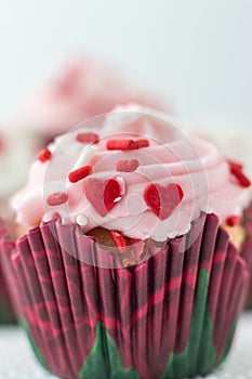 Beautiful single cupcake with icing and little red heart candy