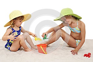 Beautiful Sisters In Beach Hats Playing In The Sand