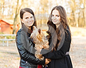 Beautiful sisters with pet dog