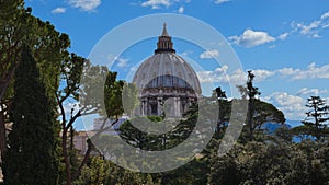 Beautiful Sistine Chapel in Vatican City is covered by the lush green treetops.