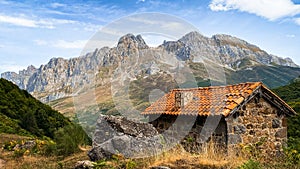 Mountain cabin with high and beautiful mountains in the background. Majada de Brez, Picos de Europa photo