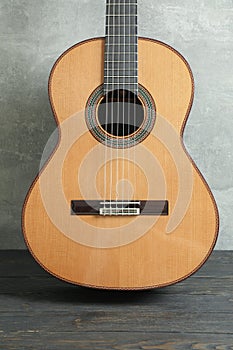 Beautiful six - string classic guitar on wooden table