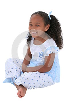 Beautiful Six Year Old Girl Sitting In Pajamas Over White