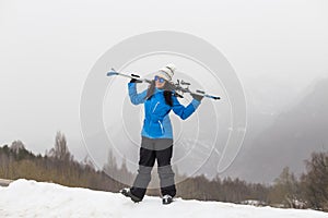 Beautiful Skier woman on top of the mountain. Fog. Winter season