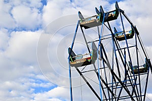 Beautiful skies filled with puffy white clouds are backdrop to Ferris wheel, York`s Wild Kingdom, Maine, 2017