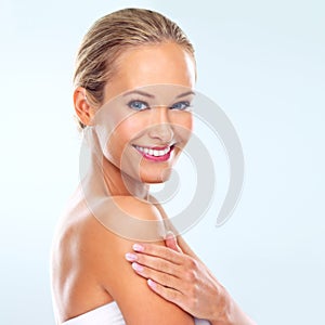 Beautiful from the skin up. Studio shot of a beautiful young woman with perfect skin against a blue background.