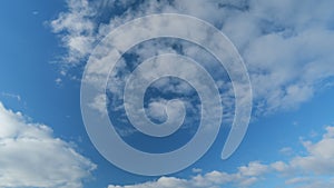 Beautiful sky background. Abstract look of natural white stratocumulus clouds showing wind direction on blue sky