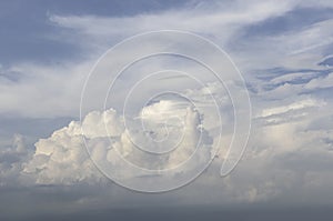 Beautiful sky.Big curly clouds in the light blue sky in soft pastel colors.