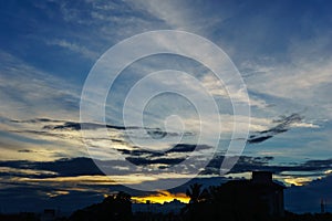 beautiful sky and cloud when sunset over city. silhouette of town when sunset at dusk with dramatic twilight sun light over sky