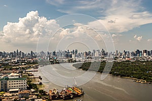 Beautiful sky and cloud view of Bangkok with skyscrapers along Chaopraya river in the afternoon