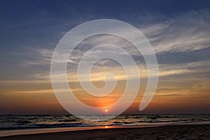 Beautiful sky colorful sunset on the ocean, natural landscapes. Deserted beach, the sun sets in the clouds above the sea