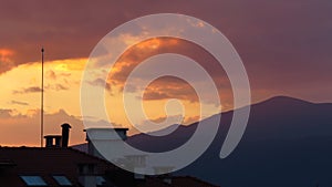 Beautiful sky and colourful clouds at sunset time over the mountains and town. Pure photo. No postprocessing no Photoshop