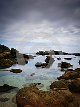 Beautiful sky over ocean water with rocks