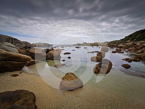 Beautiful sky over ocean water with rocks