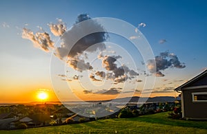 A beautiful sky at sunset over a typical American subdivision on a hillside in Spokane, Washington