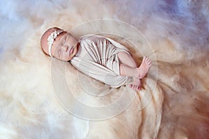 Beautiful sleeping newborn girl with a bandage on his head